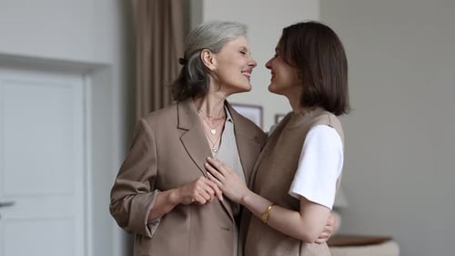 Mother and Daughter Embracing Indoors with Love