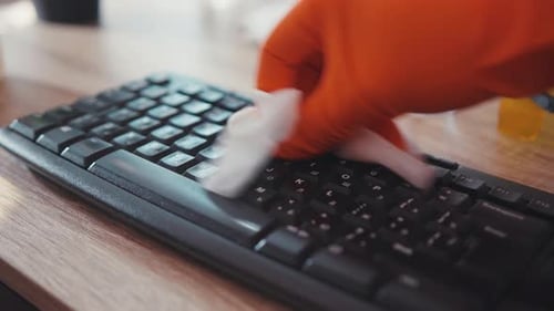 Keyboard Cleaning with Wipe and Orange Gloves