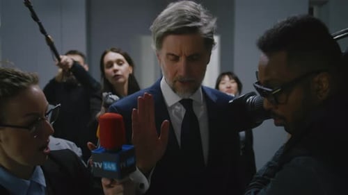 Public Figure Surrounded by Intense Press