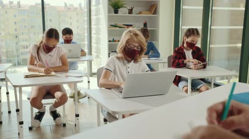Pupils Using the Computers and Tablets Sitting in the Class During Computer Science Lesson Wearing