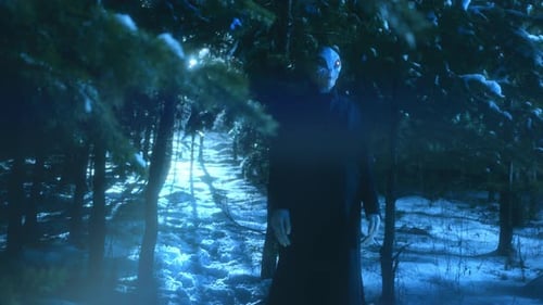 Creepy Alien Standing in Snowy Forest and Staring in the Dark