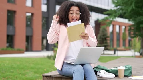 Excited Young Adult Receives Good News From Letter
