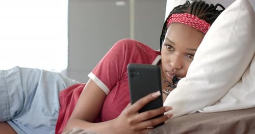 Woman in Bed Using Smartphone Device