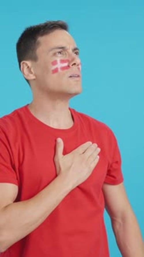 Man Listening to the Denmark National Anthem with Solemnity