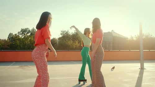 Girls in Bellbottom Trousers Riding Skates at Skating Rink