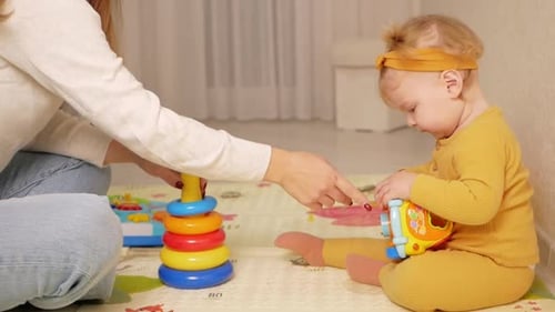 Child and Adult Playing with Toys at Home