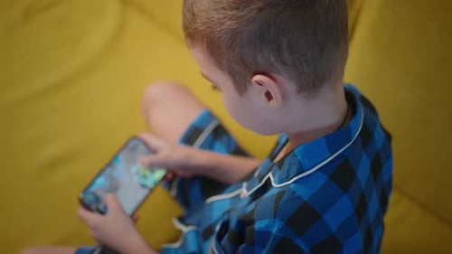 Child Plays Video Game on Mobile Phone