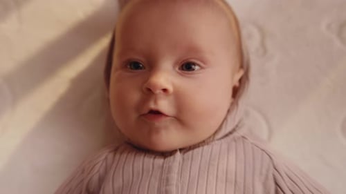 Overhead View of Funny Baby Makes Surprised Face Closeup Footage of Cute Caucasian Baby Boy Infant
