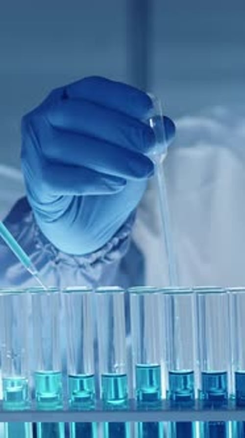 Close-up of Two Unrecognisable Researchers Working with Chemical Substances