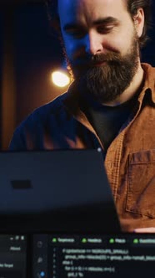 Remote IT Support Worker Standing in Home Office Programming on Laptop