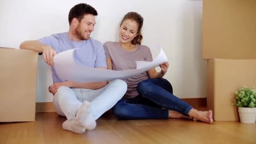 Real Estate, Mortgage and Moving Concept - Happy Couple Sitting on Floor
