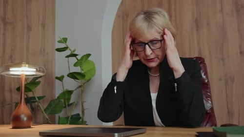 Businesswoman Gesturing at Desk in Office