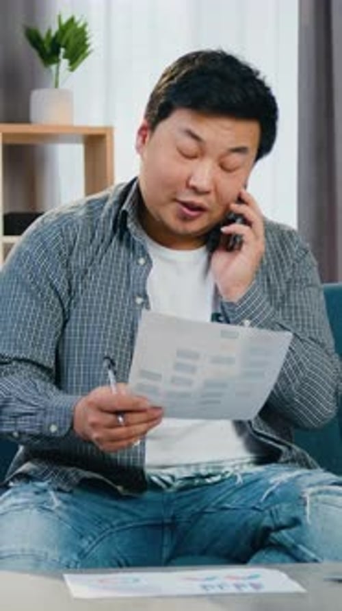 Attractive Confident in Good Mood 30Aged Chinese Male Worker Talking on Phonereading Report and