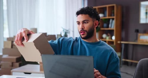 Young Adult Using Laptop for E-Commerce Business