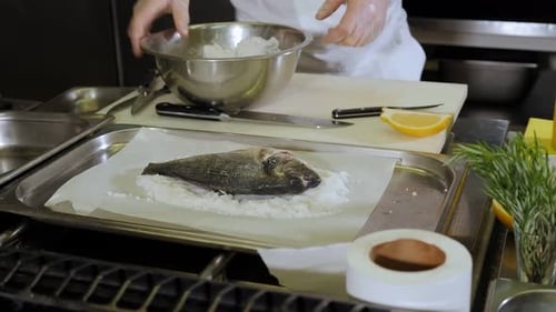 Chef Preparing Fresh Fish Dish in Kitchen
