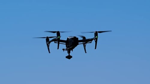 Drone Flying in a Clear Blue Sky