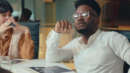 Black Business Leader Having Discussion with Colleague at Office Meeting
