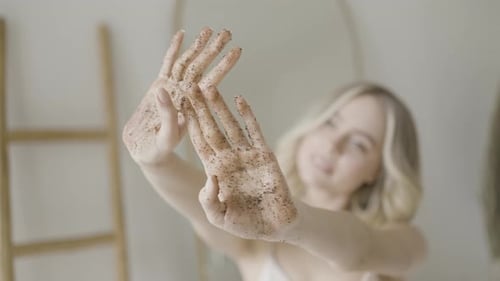 Close Up of Hands of a Pretty Blond Girl with Coffee Scrub on Them