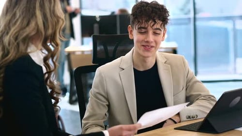 Young Adult Meeting with Colleague in Modern Office