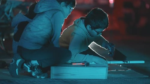 Curious Boys Building a Project Together at Night