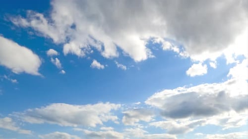 Stunning azure sky with brightly shining sun and soft cloudscape.
