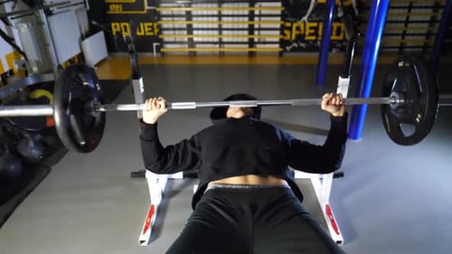 Strong Sporty Man Doing Bench Press Workout with a Barbell at Fitness Centre Young Sportsman Doing