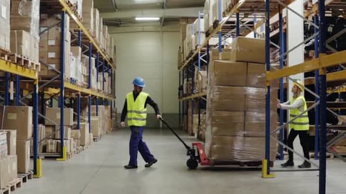 Warehouse Workers Pulling a Pallet Truck
