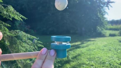 Woman Balancing Ball of Blow Pipe Toy As Analogy of Balance Life