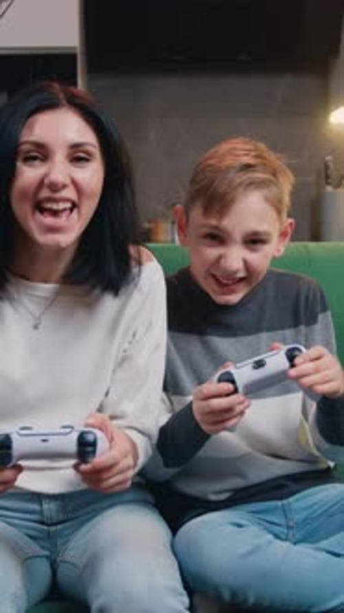 Excited Mother and Son Play Video Game Together