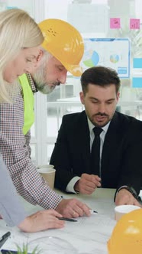 Team of Engineers Reviewing Plans in Office Setting