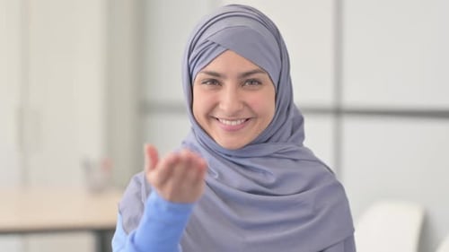 Portrait of Muslim Woman in Hijab Inviting People
