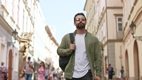 Man Walking Down Narrow City Street