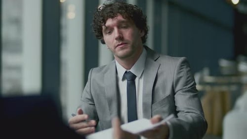Business Meeting with Documents and Handshake