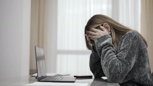 Sad Woman at Laptop in Home Office Upset
