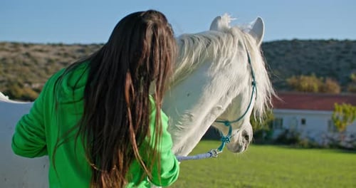 Woman Showing Genuine Care and Devotion to Her Horse in a Picturesque Ranch