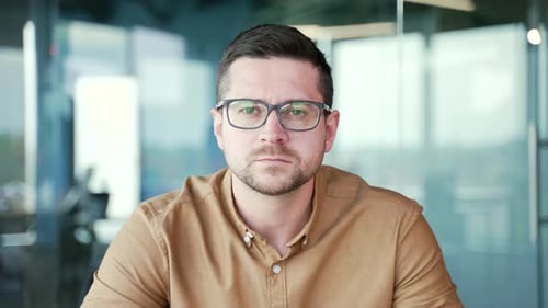 Webcam view. Close up. Businessman watching video call training looking at camera sitting