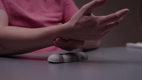 Closeup of Male Hands Performing Therapeutic Exercises for Carpal Tunnel Syndrome Prevention at