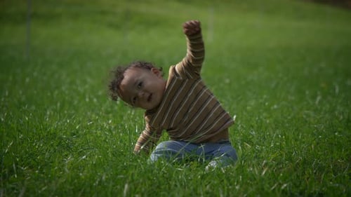 A Child Happily Exploring Nature in a Lush Green Field Surrounded By Beauty and Adventure