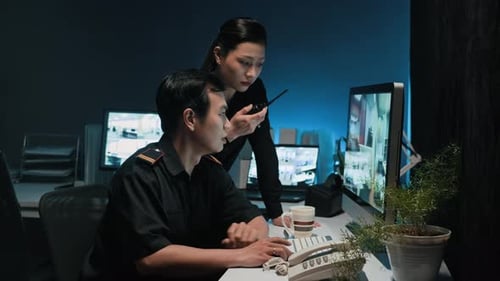 Man and Woman Working Security at Night