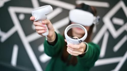 Woman Playing VR Game With Headset and Controllers