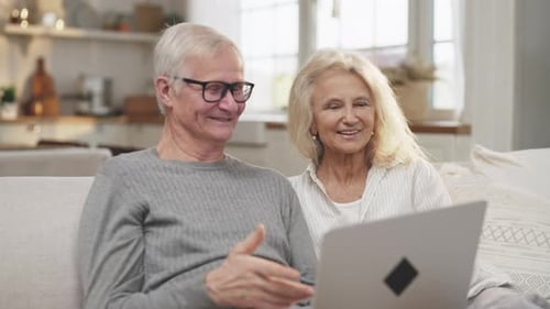 Elderly Couple Video Conferencing at Home
