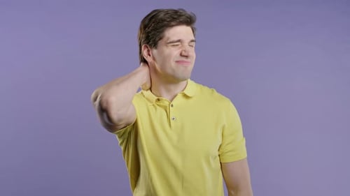 Young Adult Man Holds Sore Neck