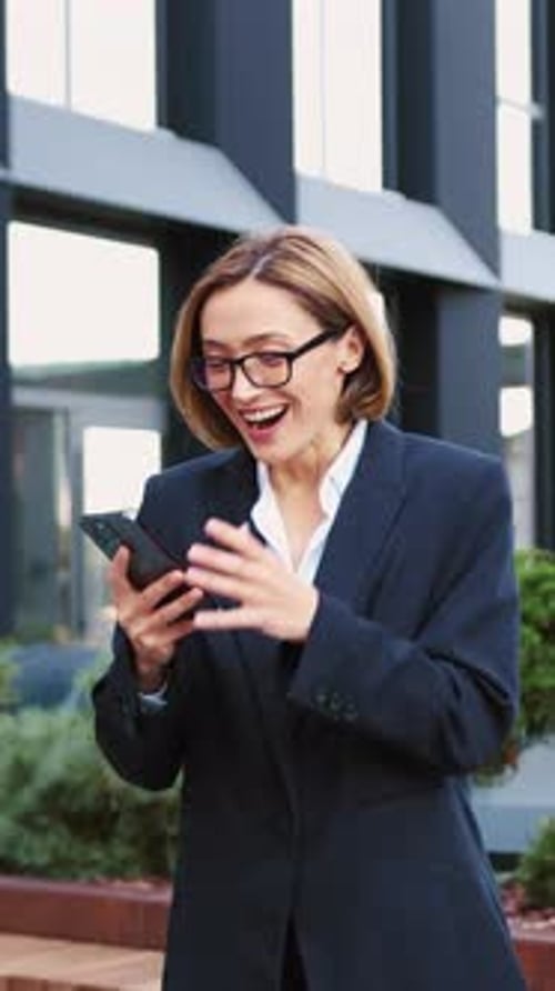Excited Business Woman Receives Good News on Phone