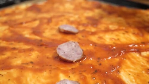 Dk 31 1. Sausage is added to the base of the pizza. Cooking homemade pizza.