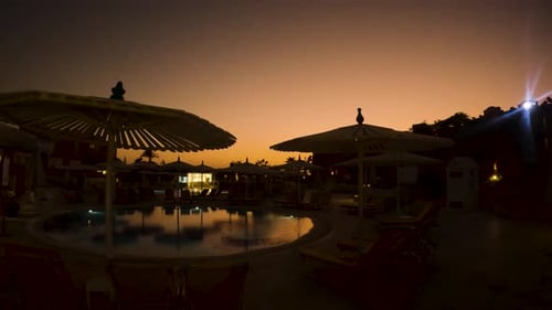 Slow establishing shot of a vibrant sunset at a Egyptian resort in summer