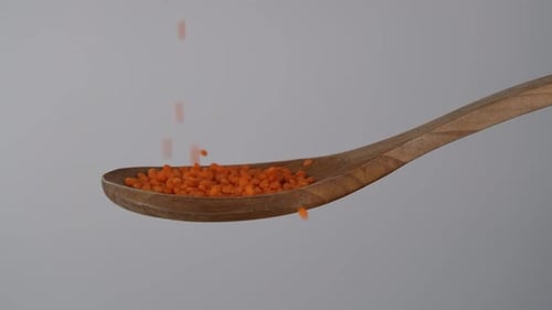Lentils Falling into Wooden Spoon