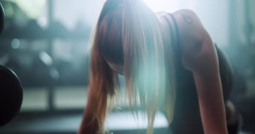 4k video footage of an attractive young sportswoman planking while working out in a gym
