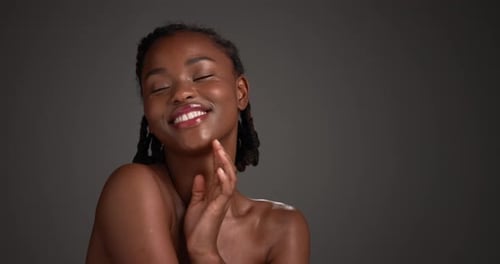 Shoulder, skincare and happy with face of black woman in studio for beauty