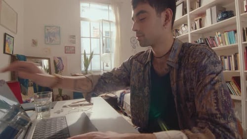Young Adult Working on Laptop at Home
