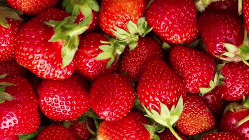 Rotating Overhead Close-Up of Ripe Red Strawberries on Flat Surface | 4K Food Background